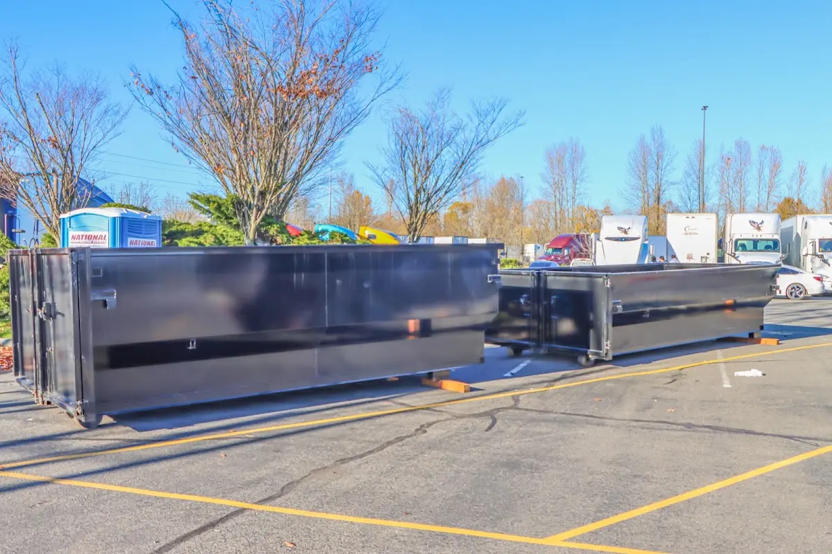 Professional dumpster rental service with roll-off container on residential driveway in Atherton